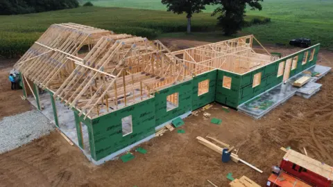 Aerial view of recently installed roof trusses on residential home.