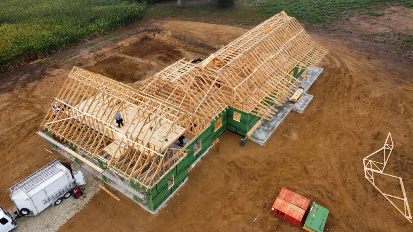 Aerial view of recently installed roof trusses on residential home.