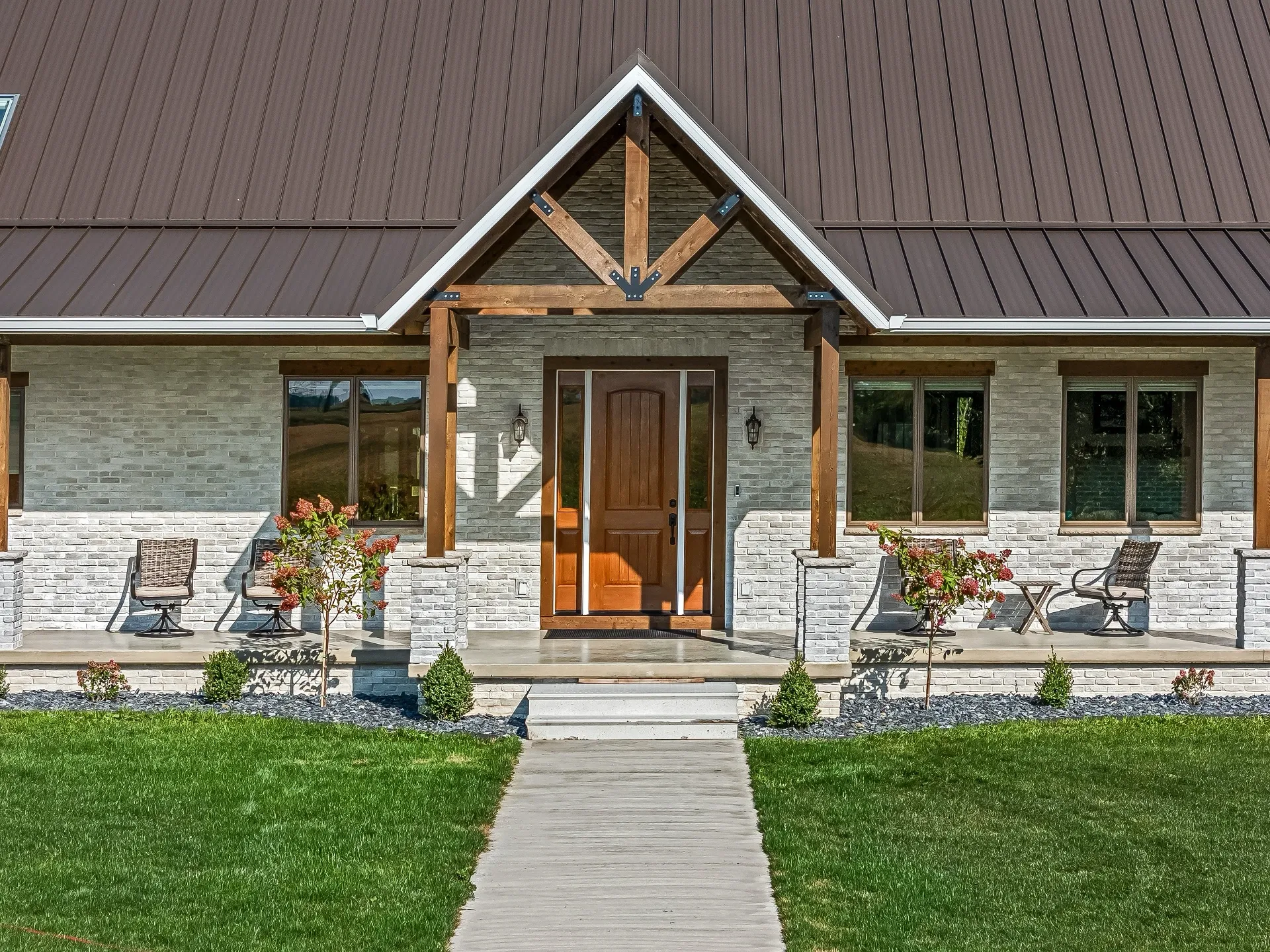 Front door with decorative truss, with pillars.
