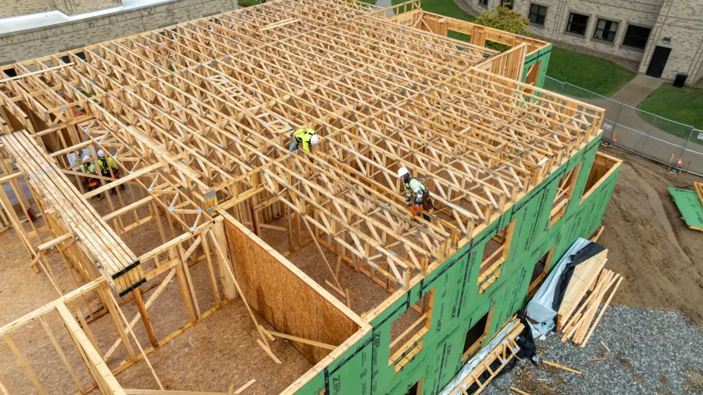 Installing floor trusses at Holy Cross College.